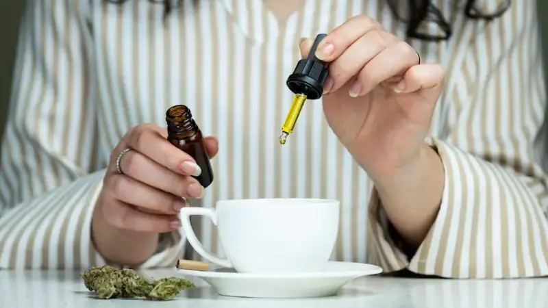 a person drop cbd oil in a cup is cbd legal in uk