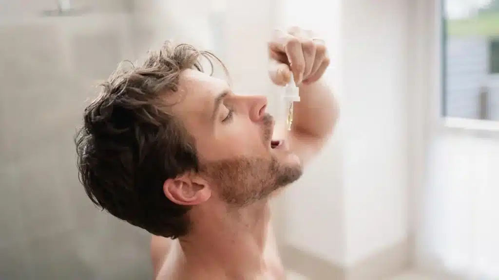 a man taking full spectrum cbd in the bathroom